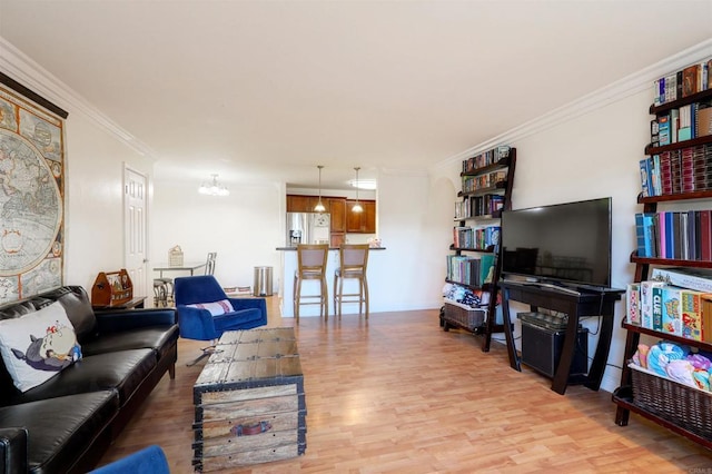 living room featuring light hardwood / wood-style floors and ornamental molding