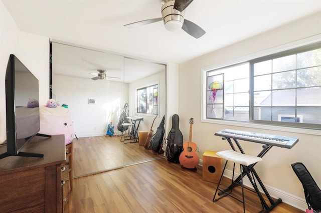 misc room featuring ceiling fan and light wood-type flooring