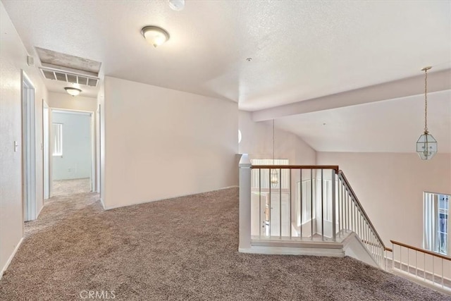 interior space featuring carpet flooring and lofted ceiling with beams