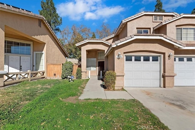 view of property featuring a garage and a front lawn