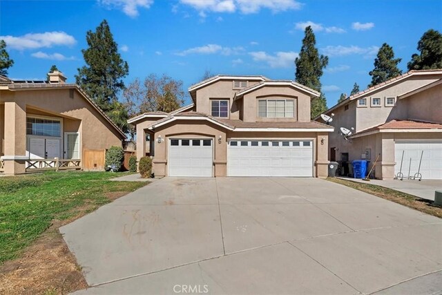 view of front property featuring a garage and a front lawn