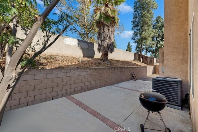 view of patio with cooling unit and area for grilling