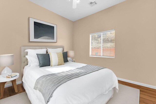 bedroom with ceiling fan and wood-type flooring