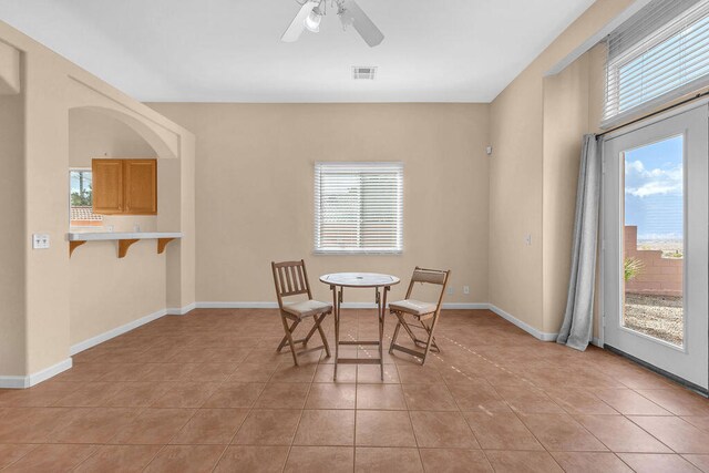 dining space with plenty of natural light, ceiling fan, and light tile patterned flooring