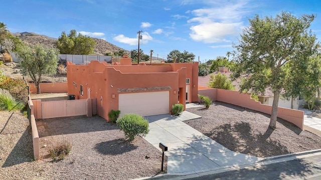 pueblo revival-style home featuring a mountain view