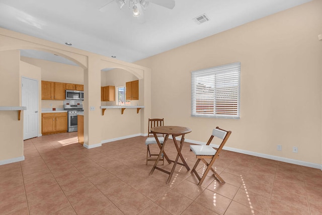 tiled dining area featuring ceiling fan