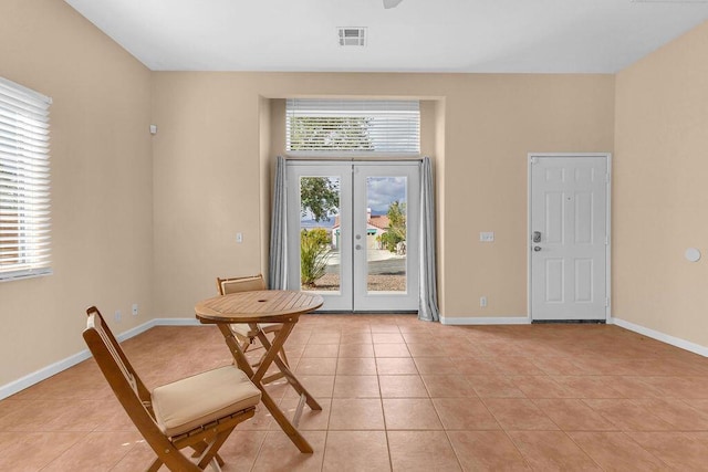 interior space featuring french doors, light tile patterned floors, and a healthy amount of sunlight