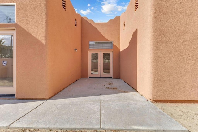 property entrance featuring french doors and a patio