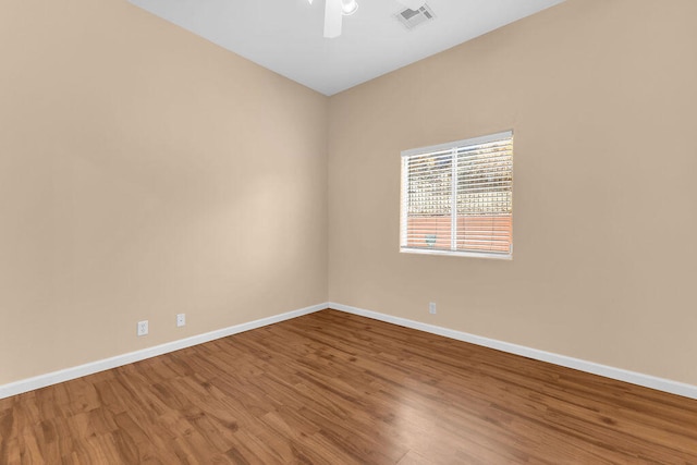 spare room featuring hardwood / wood-style flooring and ceiling fan