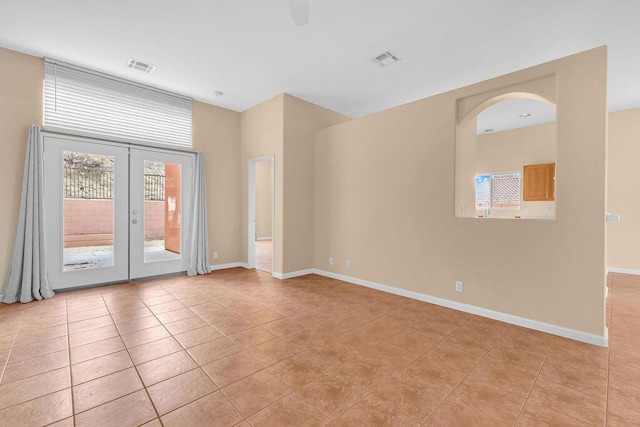 unfurnished room with french doors and light tile patterned floors