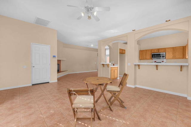 dining space with ceiling fan and light tile patterned floors