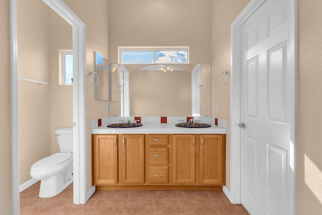 bathroom featuring tile patterned floors, vanity, and toilet