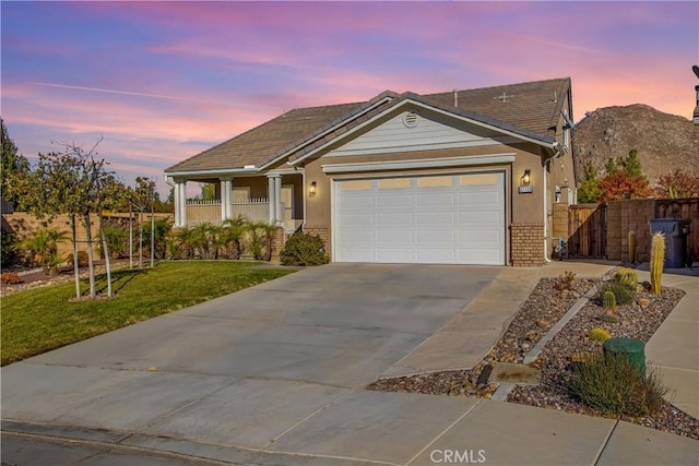 view of front of house with a garage and a yard