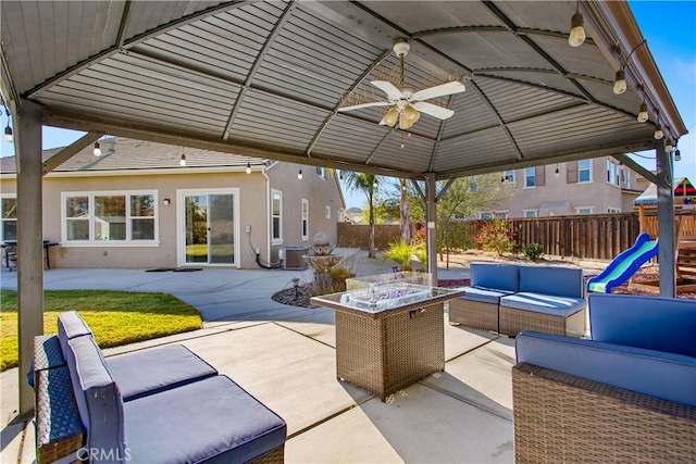 view of patio / terrace featuring a playground and an outdoor living space with a fire pit