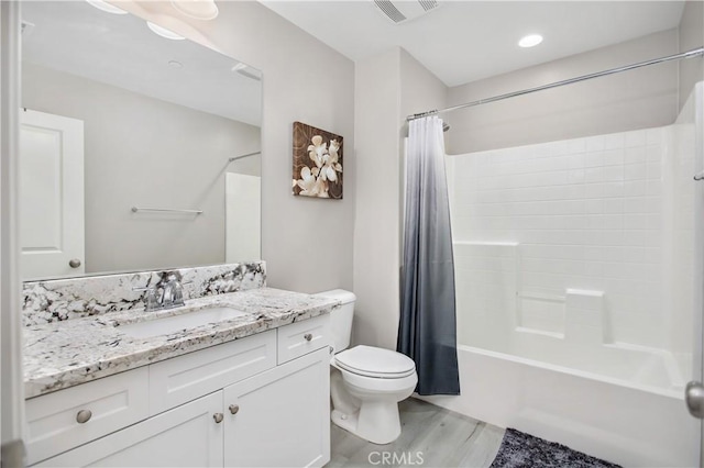 full bathroom with toilet, vanity, hardwood / wood-style flooring, and shower / tub combo with curtain