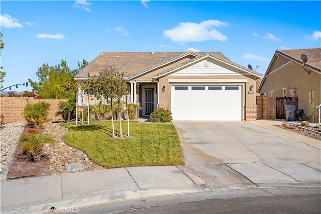 view of front of property featuring a garage and a front yard