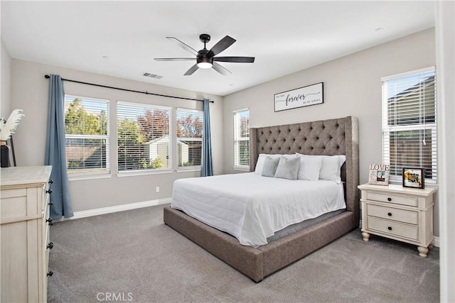 bedroom featuring multiple windows, ceiling fan, and carpet