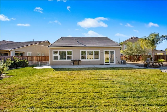 back of property featuring a yard and a patio