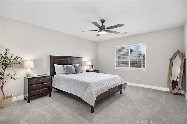 bedroom with ceiling fan and light carpet