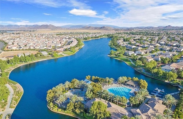 drone / aerial view featuring a water and mountain view