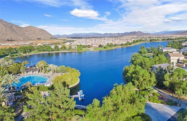 drone / aerial view featuring a water and mountain view