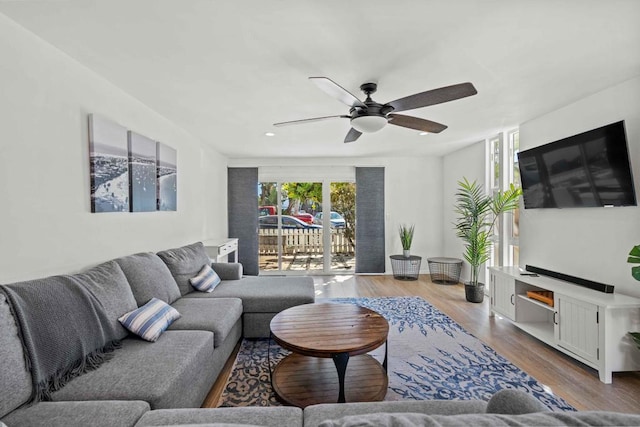 living room with ceiling fan and light hardwood / wood-style floors