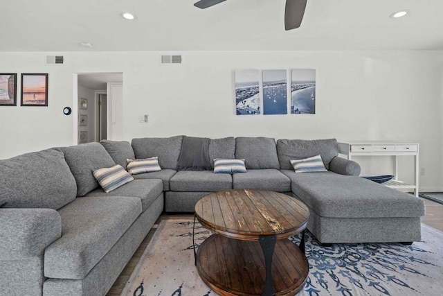 living room with hardwood / wood-style flooring and ceiling fan