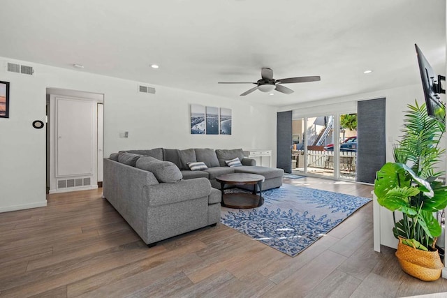 living room featuring hardwood / wood-style floors and ceiling fan