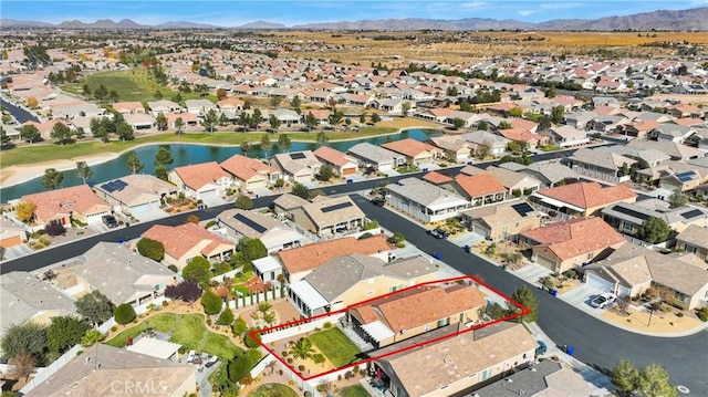 aerial view featuring a water and mountain view