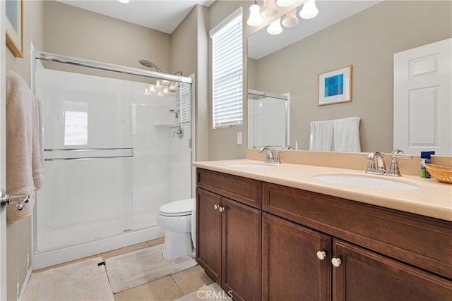 bathroom with tile patterned flooring, vanity, and a shower with shower door