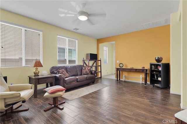 living room featuring dark hardwood / wood-style floors and ceiling fan