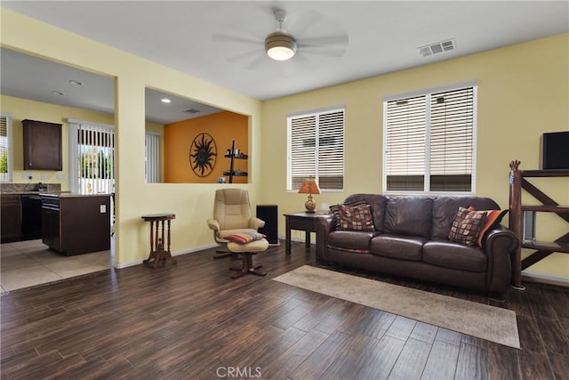 living room featuring ceiling fan, plenty of natural light, and hardwood / wood-style flooring