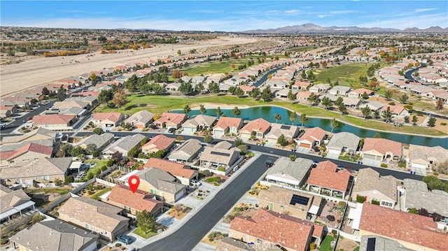 birds eye view of property with a water and mountain view