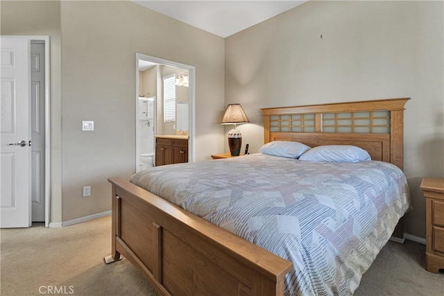 bedroom featuring ensuite bath and light colored carpet