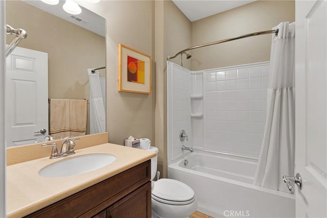 full bathroom with shower / tub combo with curtain, vanity, and toilet