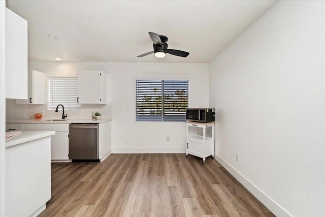 kitchen featuring white cabinetry, dishwasher, ceiling fan, sink, and light hardwood / wood-style flooring