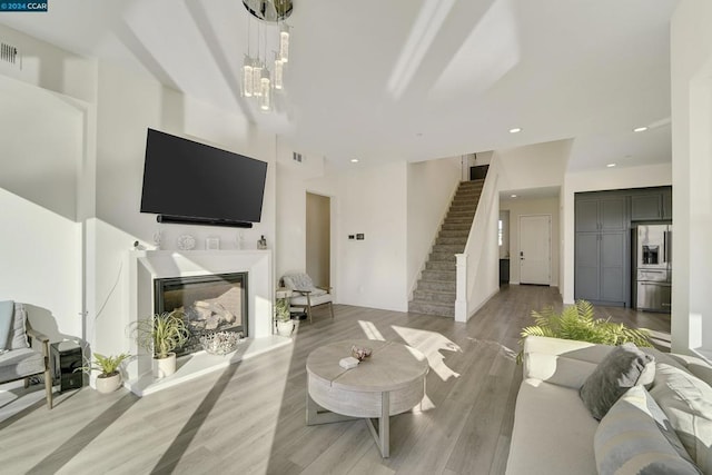 living room with hardwood / wood-style flooring and an inviting chandelier