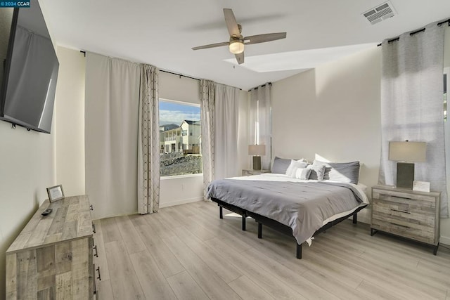 bedroom with ceiling fan and light wood-type flooring