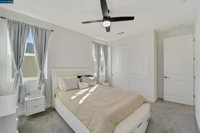 carpeted bedroom featuring a closet and ceiling fan