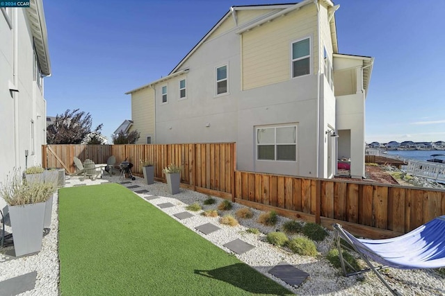 back of property featuring a lawn and a patio