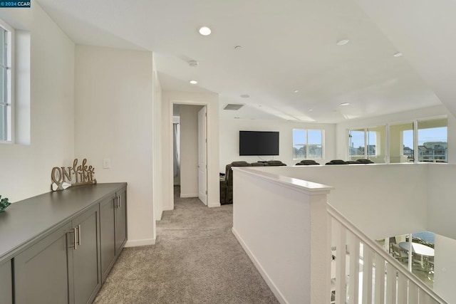 hallway featuring light colored carpet