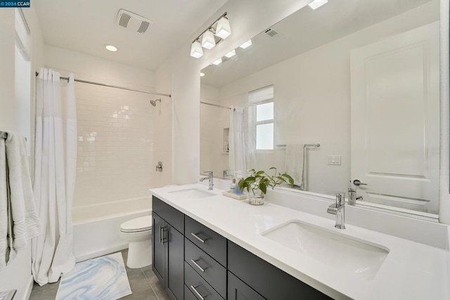 full bathroom featuring tile patterned floors, shower / tub combo with curtain, vanity, and toilet