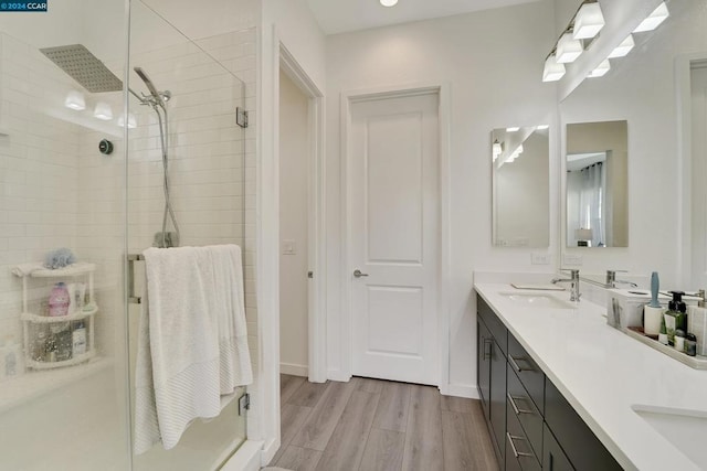 bathroom with vanity, wood-type flooring, and an enclosed shower