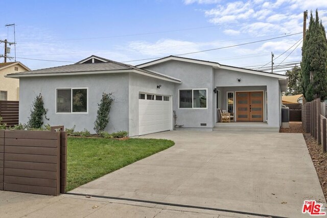 view of front facade featuring a front lawn and a garage