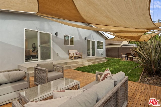 rear view of house featuring an outdoor living space, a yard, and a deck