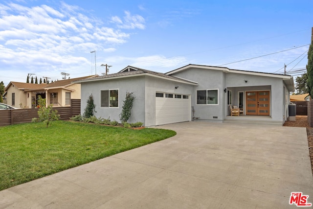 view of front of house featuring a garage and a front lawn