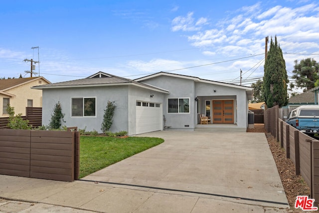 view of front of property with a garage and a front lawn