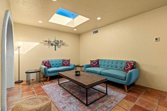 living room featuring a skylight