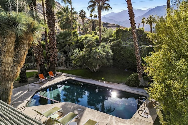 view of swimming pool with a mountain view and a patio area