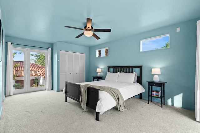 carpeted bedroom with ceiling fan and a closet